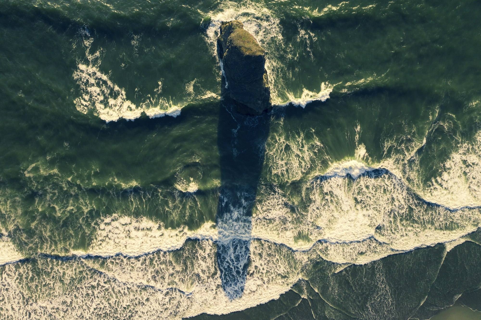 Aerial view of a sea stack in the surf, Curry County, Oregon